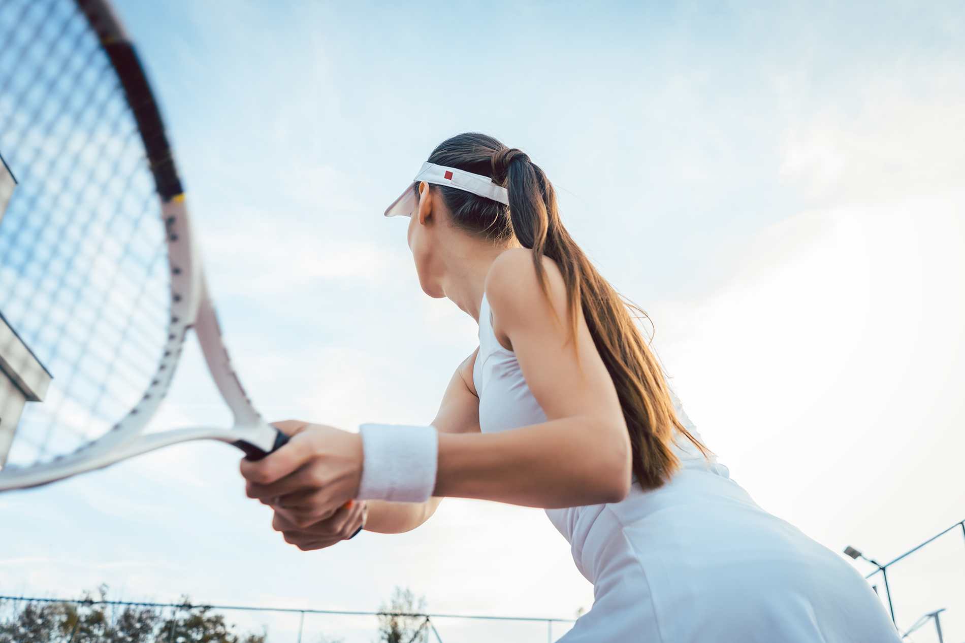 Woman giving return playing tennis on court