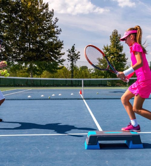 stock-photo-male-trainer-girl-tennis-training (4)